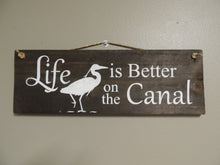 Life is better on the canal sign with great blue heron